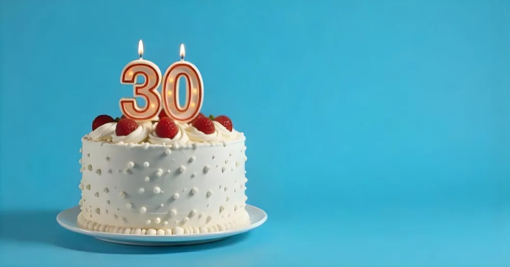 A Cake With Strawberries And Raspberries On Top With A Number 30 Candle On A Blue Background 16 A8e4