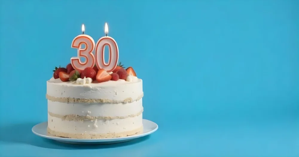 A Cake With Strawberries And Raspberries On Top With A Number 30 Candle On A Blue Background 3 7ecb