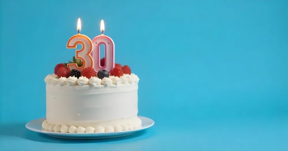 A Cake With Strawberries And Raspberries On Top With A Number 30 Candle On A Blue Background 8 Eeea