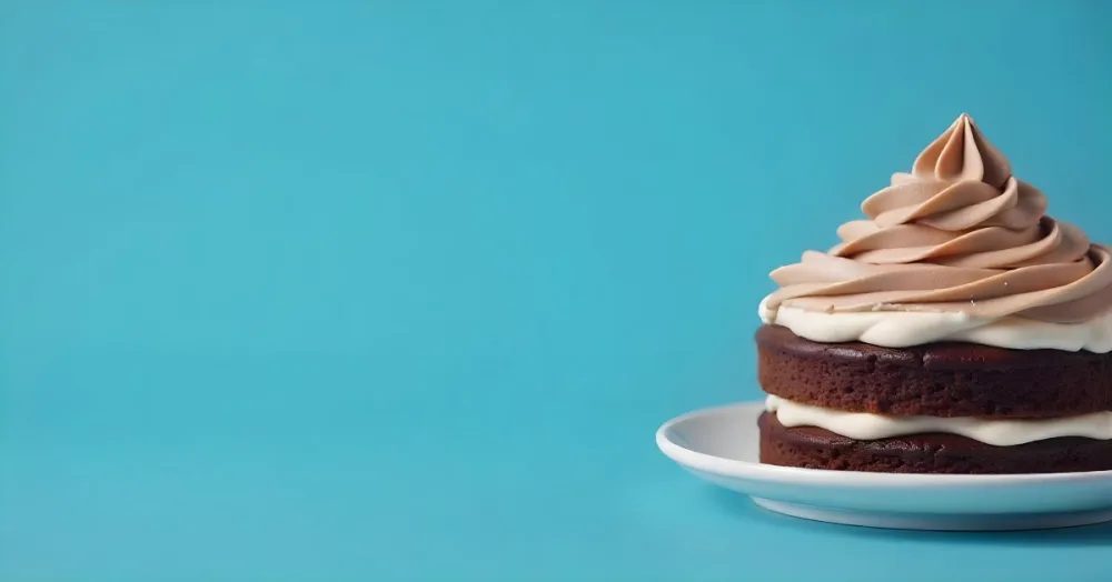 A Chocolate Cake With Chocolate Frosting On A White Plate Plain Blue Background Studio Shot Minimalist Food Photography 2 8a96