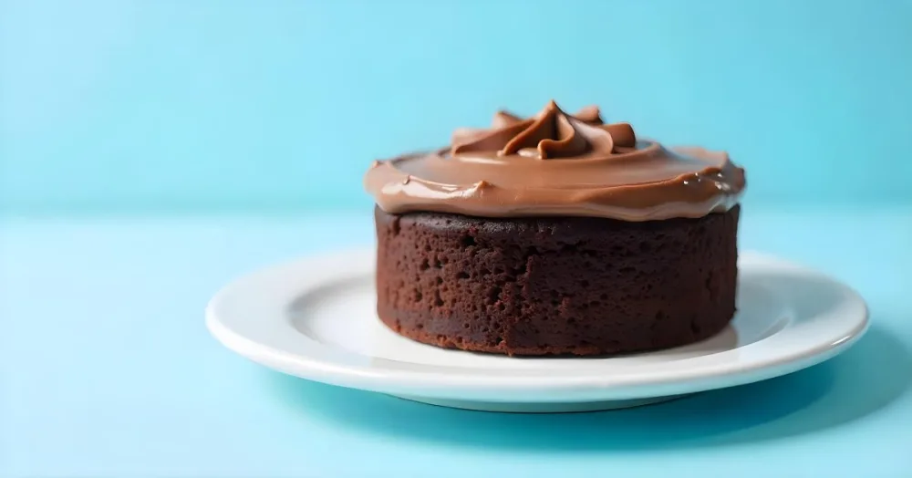 A Chocolate Cake With Chocolate Frosting On A White Plate Plain Blue Background Studio Shot Minimalist Food Photography 4 0795