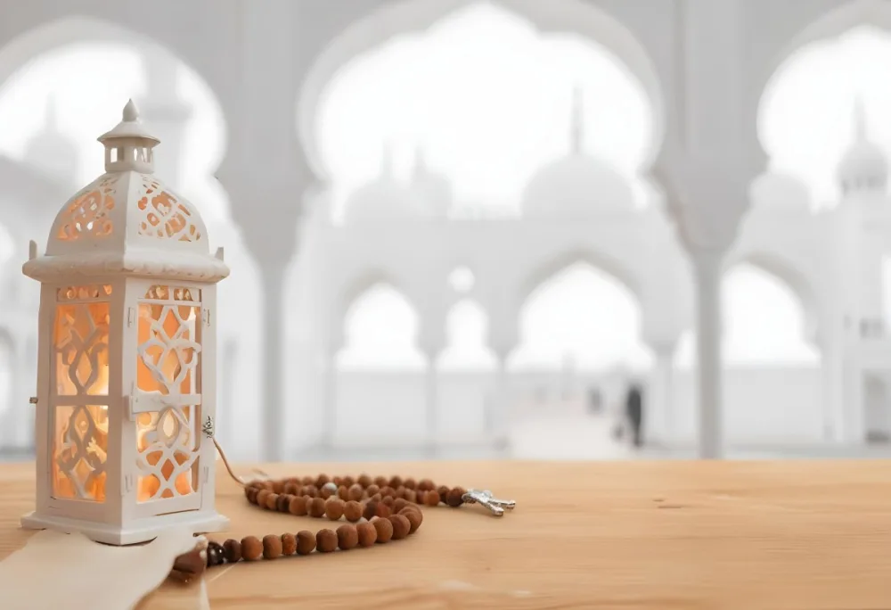 A Lantern And A Tasbih On A Wooden Table In The Background A Mosque With White Arches 14 509b