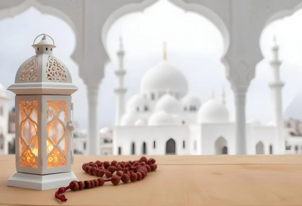 A Lantern And A Tasbih On A Wooden Table In The Background A Mosque With White Arches 16 83cf