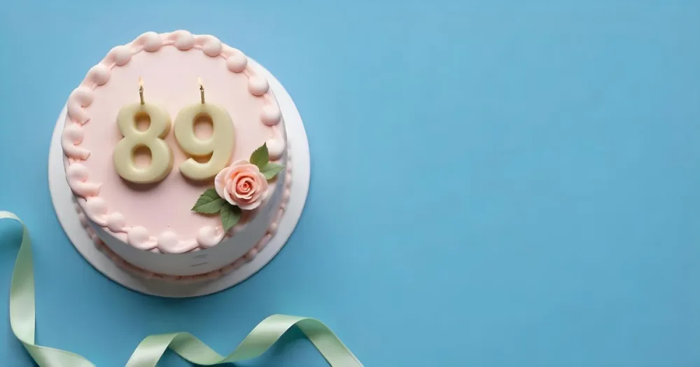 A Pink Cake With Number 89 Candles And A Rose Decoration On Top A Light Green Ribbon On A Blue Background 4 74cc