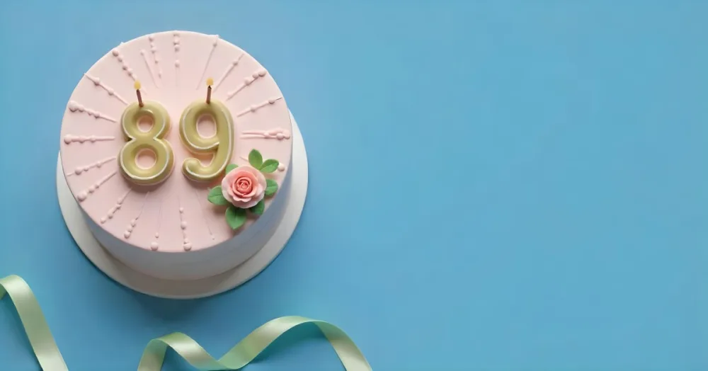 A Pink Cake With Number 89 Candles And A Rose Decoration On Top A Light Green Ribbon On A Blue Background 5 Bec6