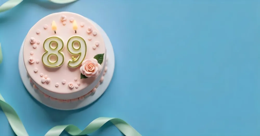 A Pink Cake With Number 89 Candles And A Rose Decoration On Top A Light Green Ribbon On A Blue Background 6 3fc7