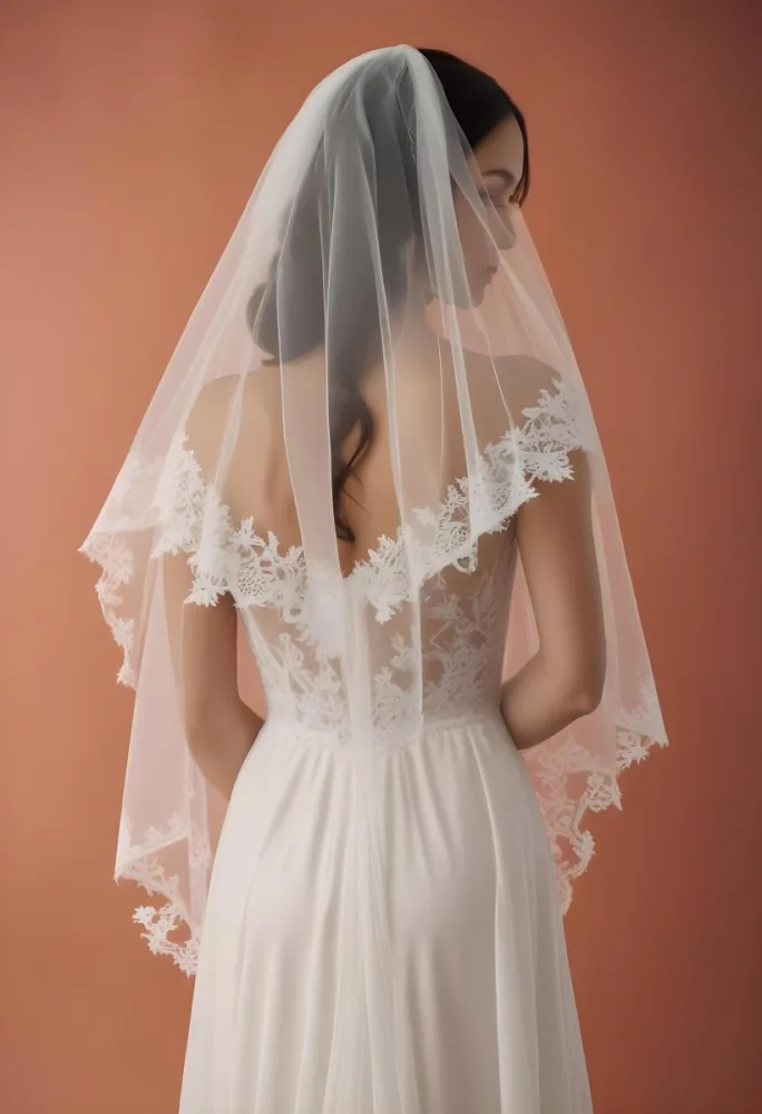 A White Wedding Dress With A Long Flowing Veil Featuring Lace Detailing 8 D018