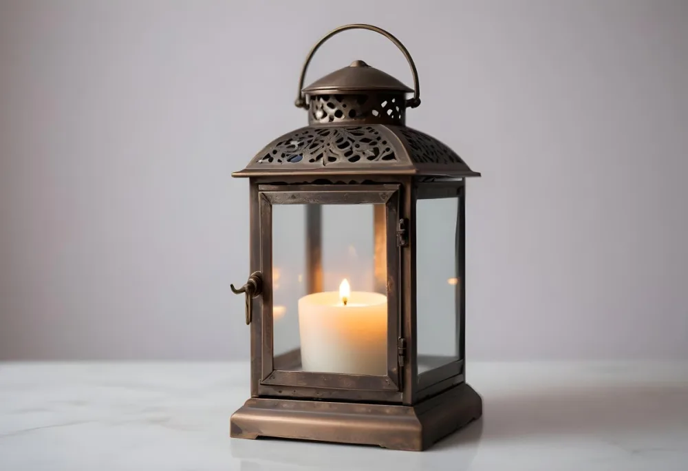 An Antique Metal Lantern With Glass Panels Sits On A Glass Surface A Candle Burning Inside Against A Blurred White Background 34 13cc