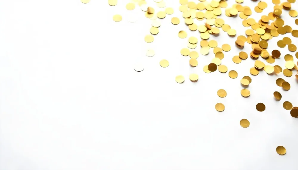 Golden Confetti Scattered On A White Surface Creating A Textured And Shimmering Effect Ideal For Festive Backgrounds Or Celebratory Designs With A Clean And Minimalist Aesthetic 1 76be
