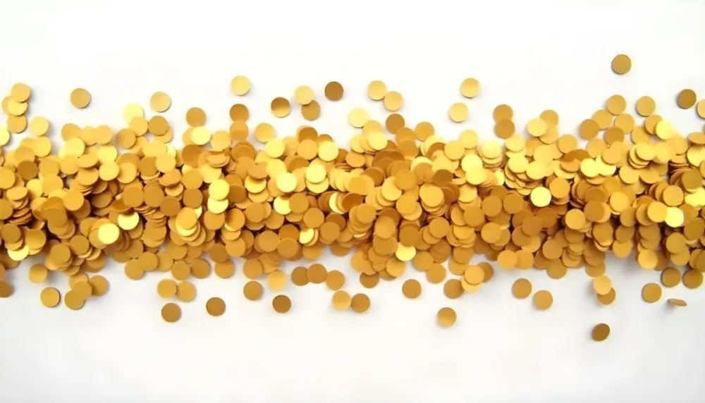 Golden Confetti Scattered On A White Surface Creating A Textured And Shimmering Effect Ideal For Festive Backgrounds Or Celebratory Designs With A Clean And Minimalist Aesthetic 26 3c47