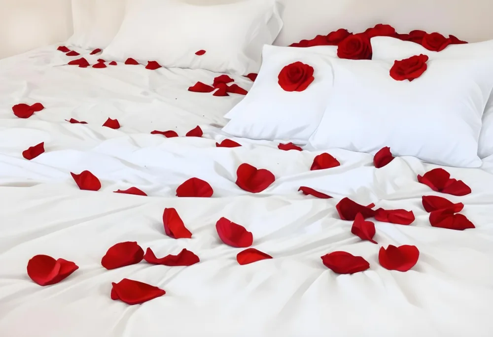 White Bed With Red Pillows And Sheets Covered With Red Rose Petals In A Bedroom 5 6e13