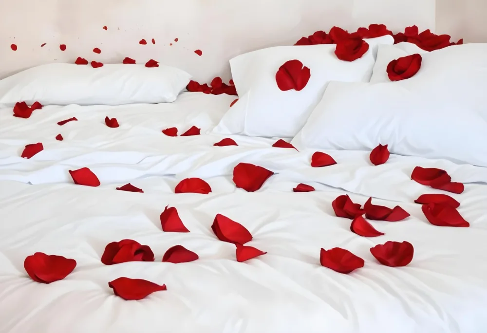 White Bed With Red Pillows And Sheets Covered With Red Rose Petals In A Bedroom 6 D1bd