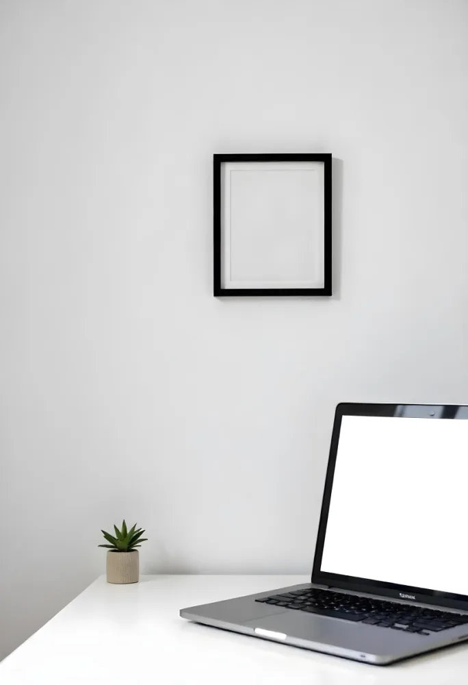 A Black Picture Frame On A White Wall With A Small Potted Plant In The Foreground 4 909e