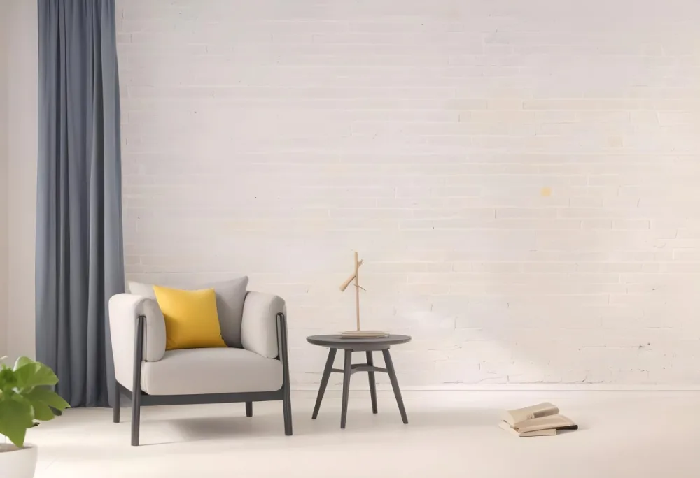 A Gray Armchair With A White Pillow Next To A Small Table With A Book And Some Sticks In A Yellow Room 8 Aaee