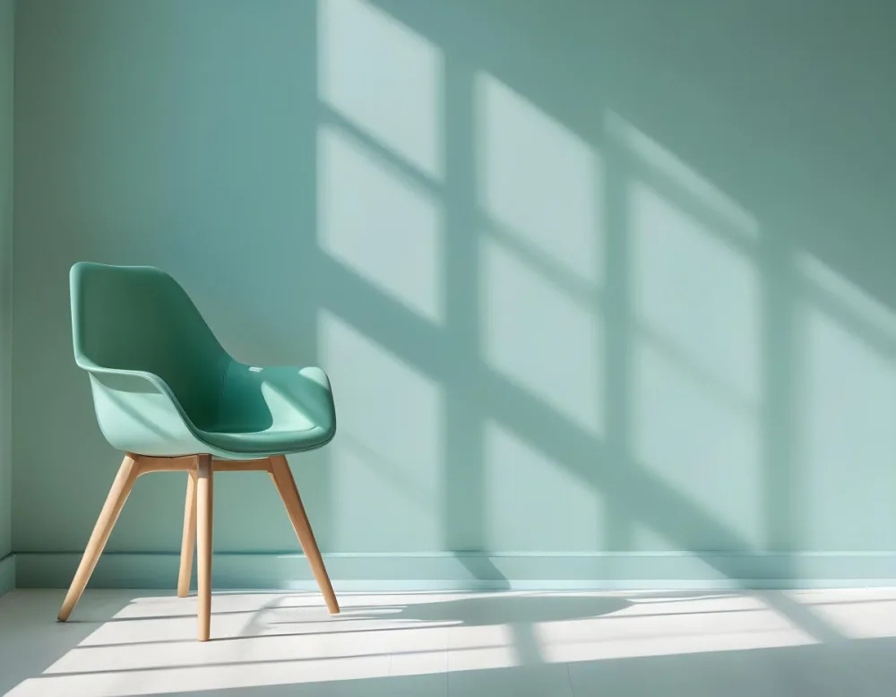 A Green Armchair With Wooden Legs In A Minimalist Room With A Green Wall And Natural Light Coming Through A Window 30 5ff5