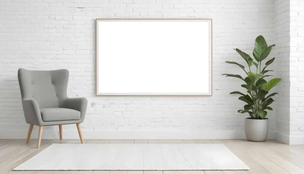 A Minimalist Interior Scene Featuring A White Brick Wall A Large Empty White Frame Mounted On The Wall A Light Colored Wooden Floor A Soft White Rug A Small Green Potted Plant Beside The Frame And A Simple Gray Ar 24 B383