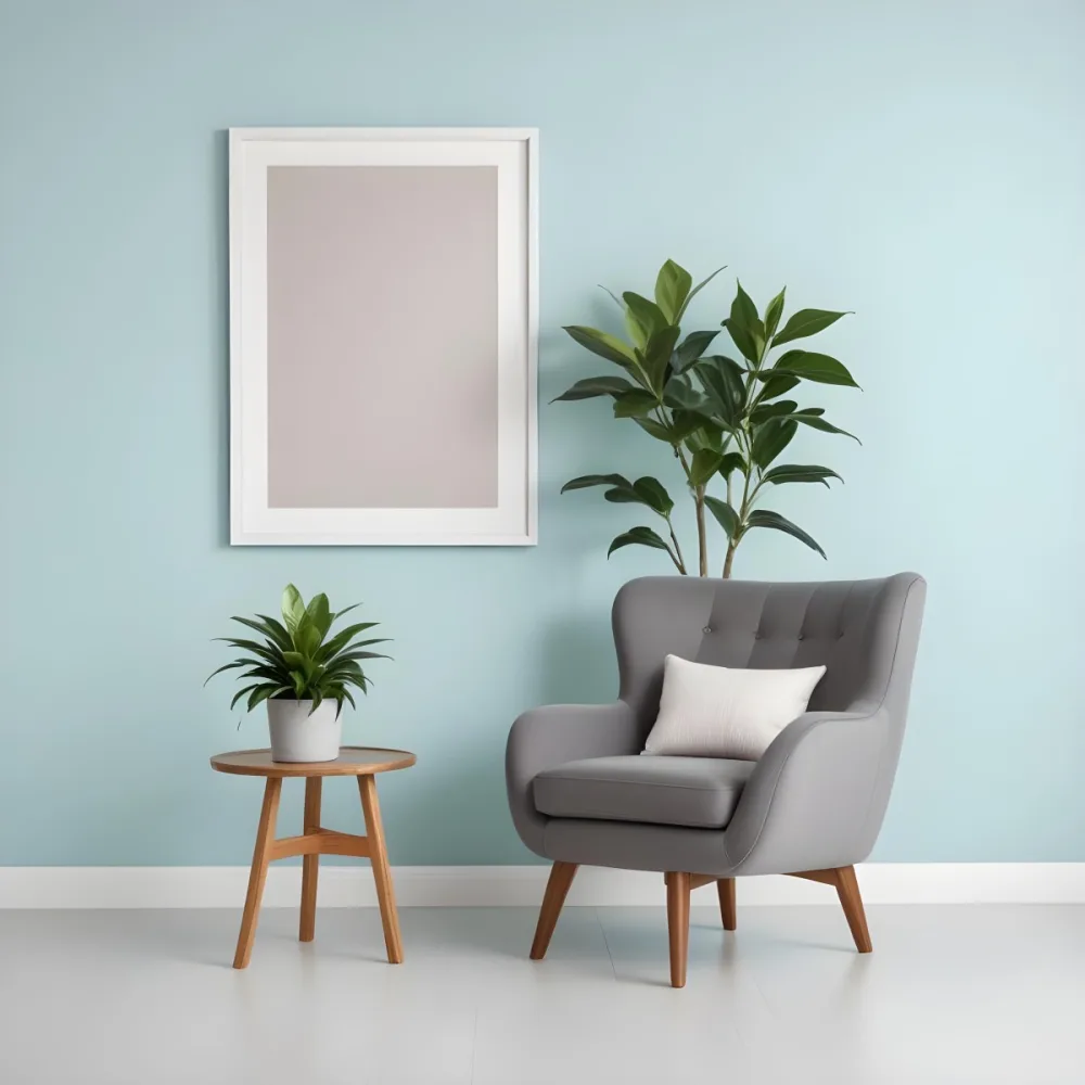 A Modern Living Room With A Gray Armchair A White Framed Wall Art And A Wooden Side Table With A Potted Plant 27 E139