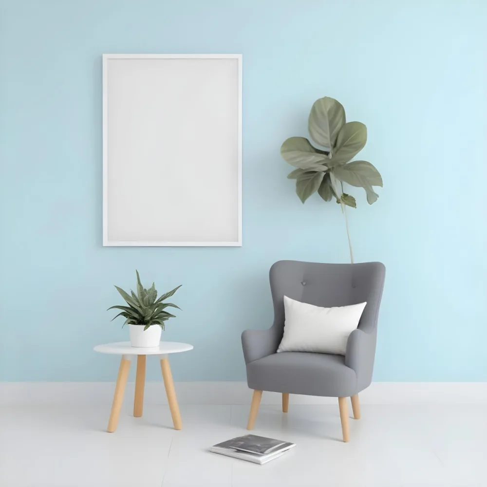 A Modern Living Room With A Gray Armchair A White Framed Wall Art And A Wooden Side Table With A Potted Plant 61 Fb20