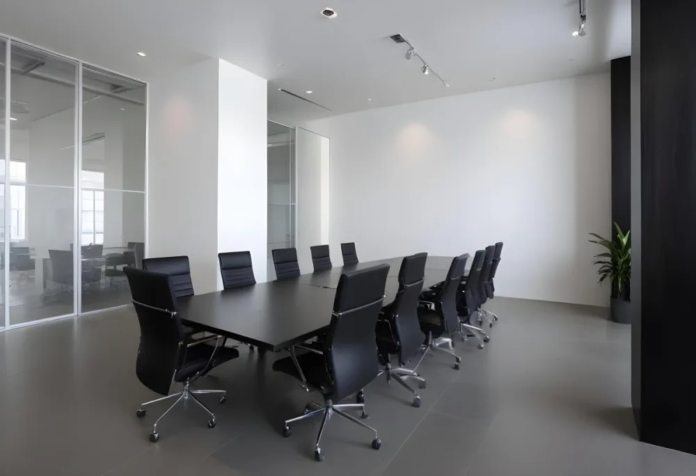 A Modern Minimalist Conference Room With A Large Rectangular Table Surrounded By Black Leather Chairs The Room Has A Sleek Monochrome Design With Recessed Lighting 30 Ce0b
