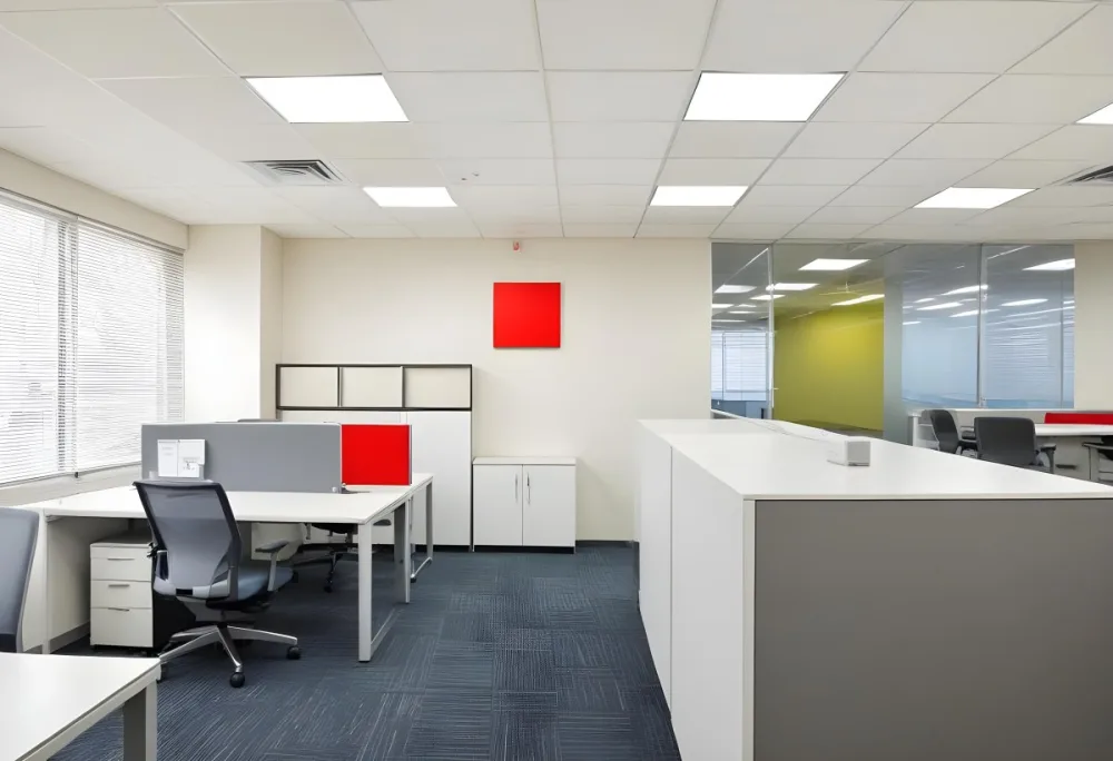 An Open Office Space With Desks Desks And Chairs The Walls Are Painted In A Combination Of Red And Gray Colors And The Ceiling Has Recessed Lighting Fixtures The Overall Style Appears To Be A M 17 Cc13
