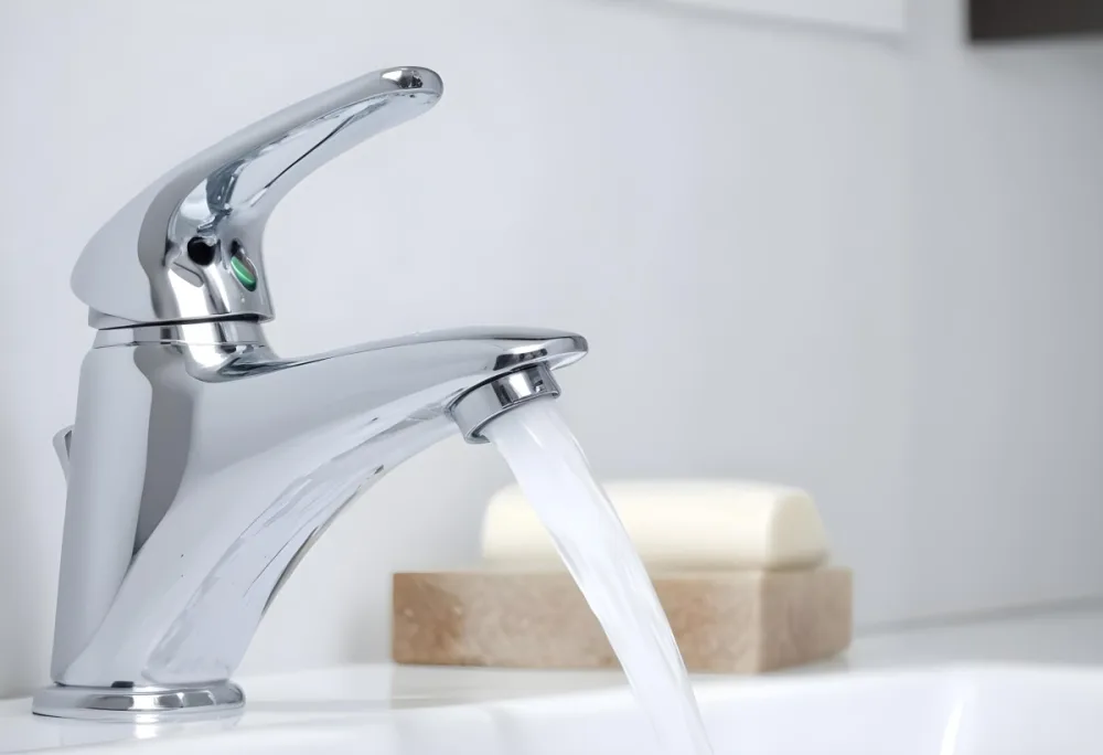 A Chrome Faucet With Water Running In A White Sink With A Soap Dish In The Background 8 7930