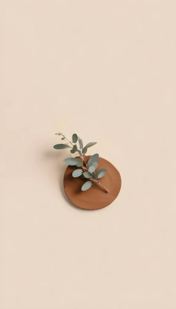 A Eucalyptus Branch On A Wooden Coaster Minimalist Style Light Beige Background Natural Lighting Clean And Simple Composition Natural Elements Neutral Color Palette 13 174f