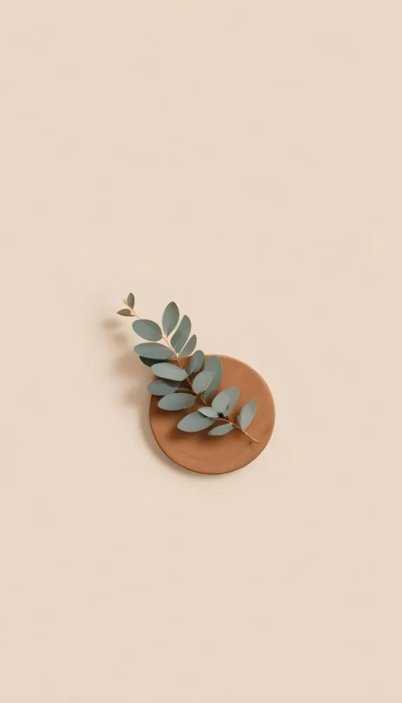 A Eucalyptus Branch On A Wooden Coaster Minimalist Style Light Beige Background Natural Lighting Clean And Simple Composition Natural Elements Neutral Color Palette 22 0f13