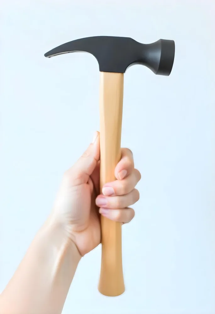 A Fair Skin Hand Holding A Hammer With A Wooden Handle White Background 8 0435