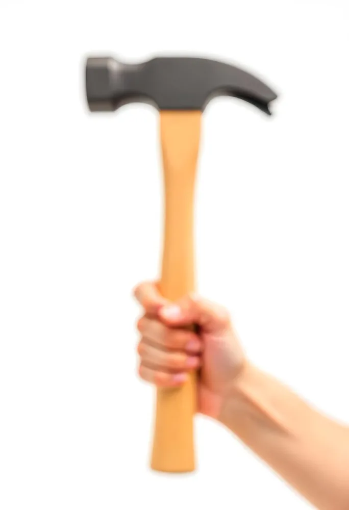 A Fair Skin Hand Holding A Hammer With A Wooden Handle White Background 9 3aab