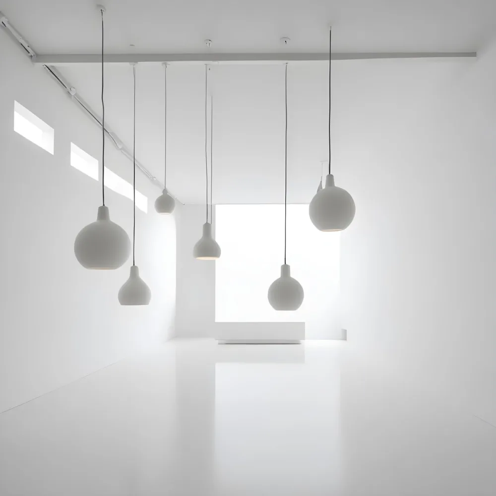 A Minimalist White Room With A High Ceiling And Hanging Pendant Lights 44 0af7