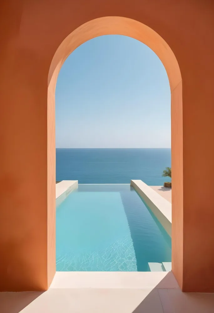 A Modern Infinity Pool Overlooking A Calm Turquoise Ocean Under A Clear Sky Framed By An Arched Doorway With Orange Walls 3 0480