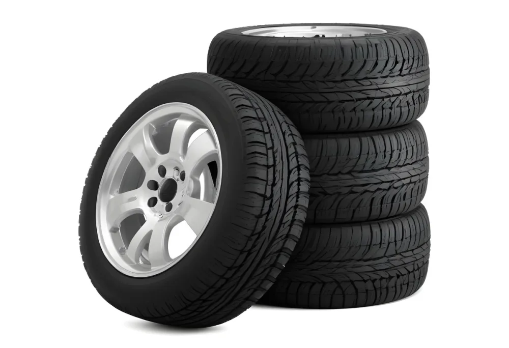 A Stack Of Four Black Tires With Black Rims One Tire Is Leaning Against The Stack The Background Is Black 14 C5f8