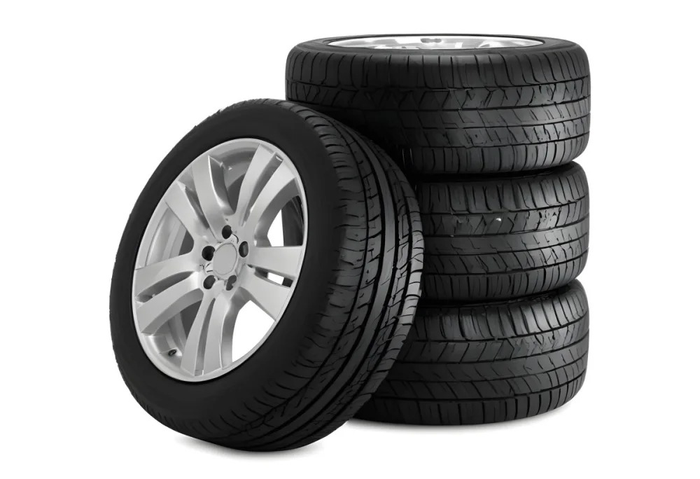 A Stack Of Four Black Tires With Black Rims One Tire Is Leaning Against The Stack The Background Is Black 15 76cb