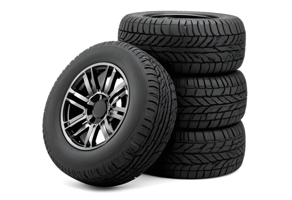 A Stack Of Four Black Tires With Black Rims One Tire Is Leaning Against The Stack The Background Is Black 2 E4f2