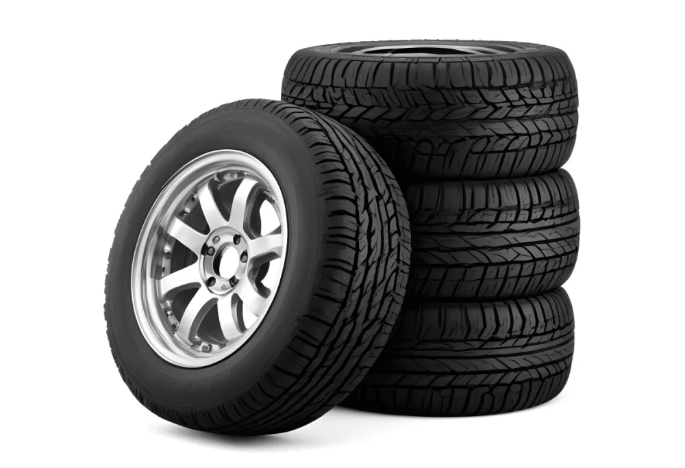 A Stack Of Four Black Tires With Black Rims One Tire Is Leaning Against The Stack The Background Is Black 20 F4f6