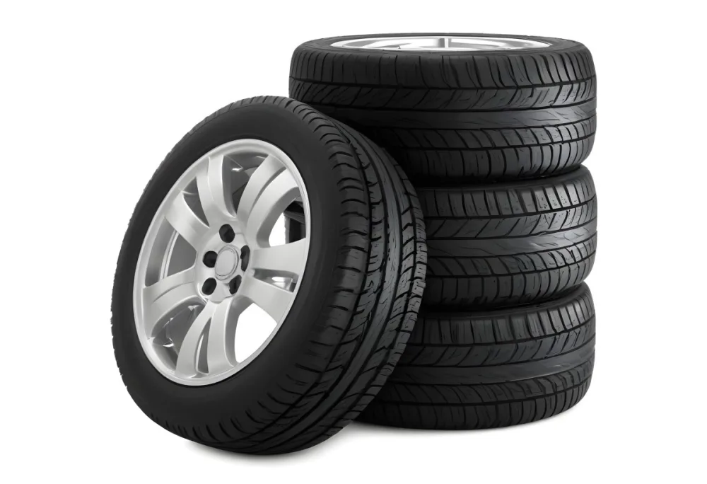 A Stack Of Four Black Tires With Black Rims One Tire Is Leaning Against The Stack The Background Is Black 5 0bc1