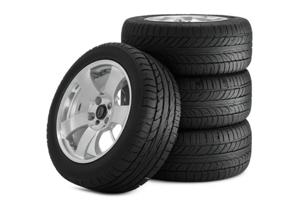 A Stack Of Four Black Tires With Black Rims One Tire Is Leaning Against The Stack The Background Is Black 8 Be87