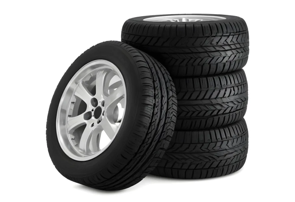 A Stack Of Four Black Tires With Black Rims One Tire Is Leaning Against The Stack The Background Is Black 9 40d1
