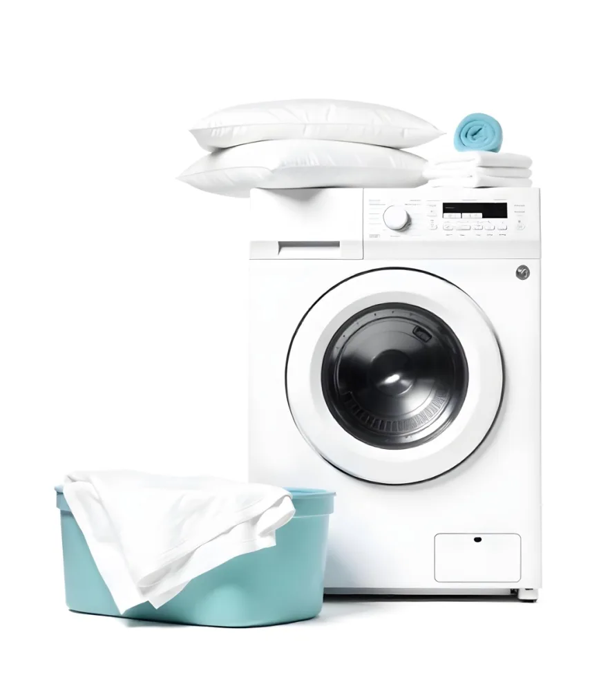 A White Washing Machine With Three White Pillows And Three Towels On Top A Blue Basket With White Clothes On A White Background 27 8baf