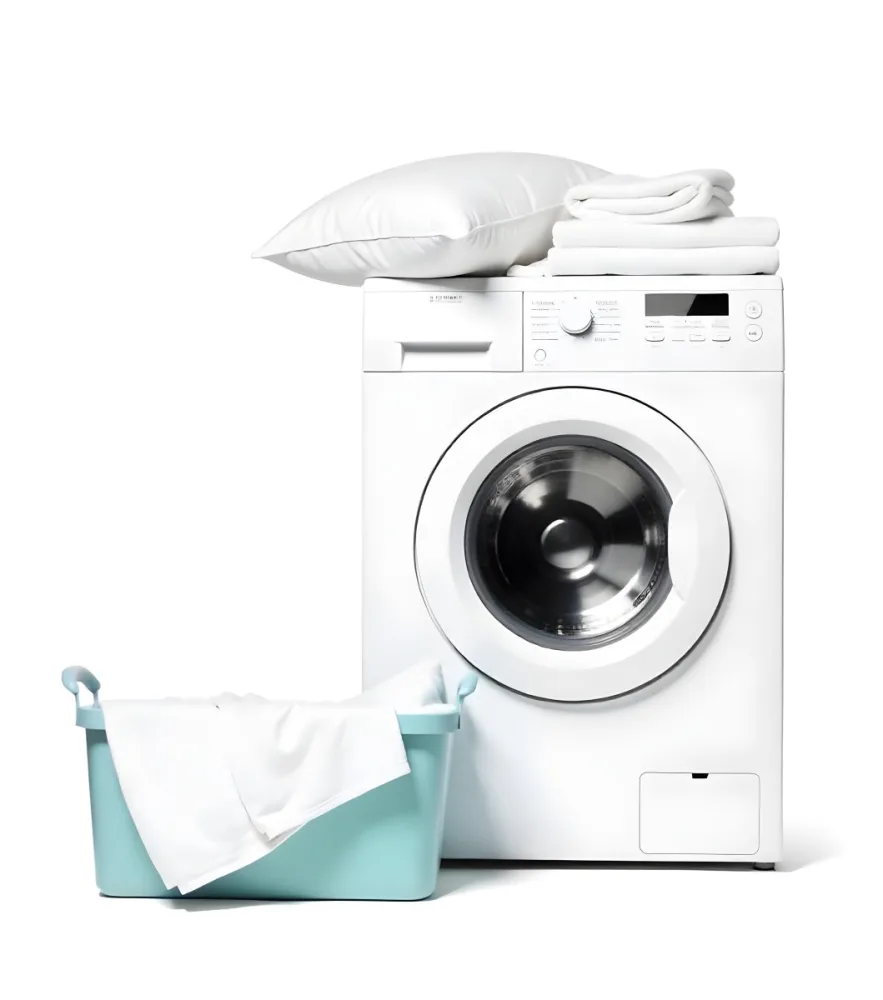 A White Washing Machine With Three White Pillows And Three Towels On Top A Blue Basket With White Clothes On A White Background 30 5b72