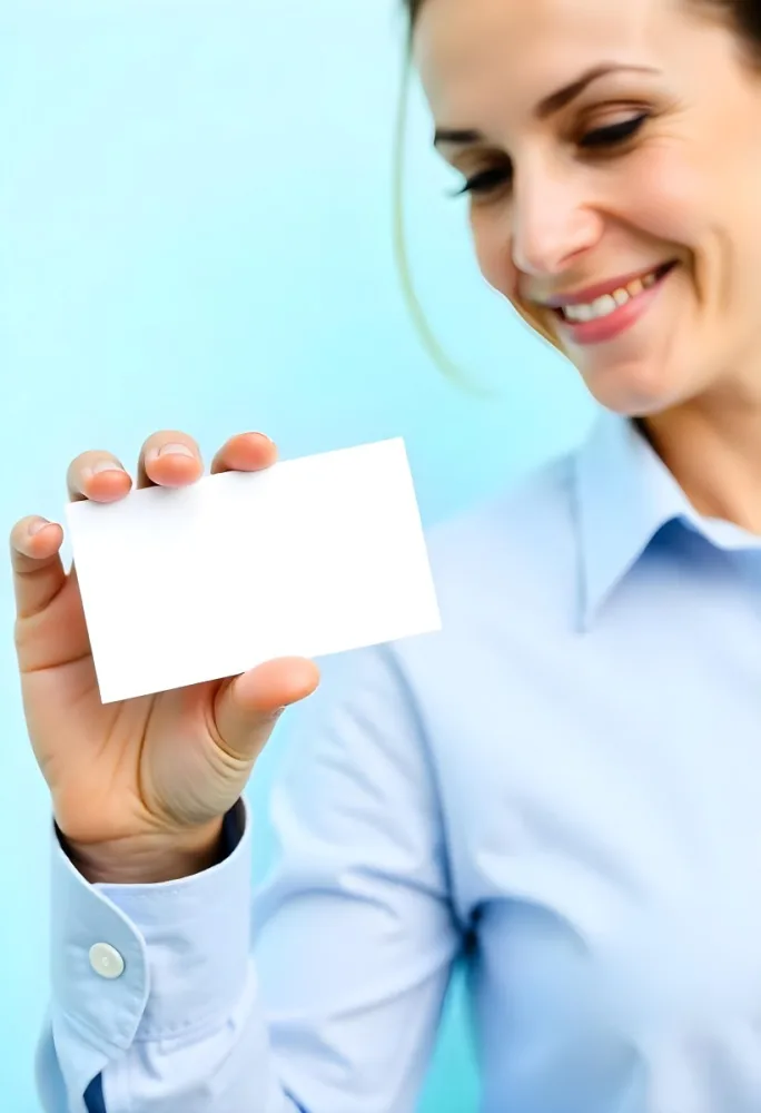 A White Woman Age 35 With A Blue Shirt Holding A Blank Business Card With A Bright Background 18 C72d