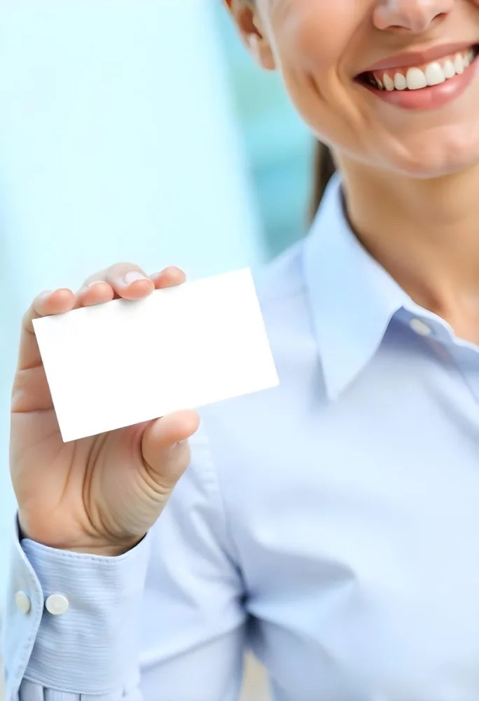 A White Woman Age 35 With A Blue Shirt Holding A Blank Business Card With A Bright Background 4 8b5c