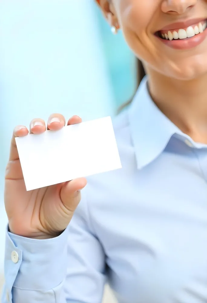 A White Woman Age 35 With A Blue Shirt Holding A Blank Business Card With A Bright Background 7 6a44
