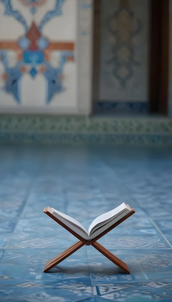 An Open Book Resting On A Wooden Stand Positioned On A Patterned Blue Floor The Background Features Blurred Architectural Elements Suggesting A Serene Indoor Space Possibly A Mosque Or A Similar Setting 18 5b6d
