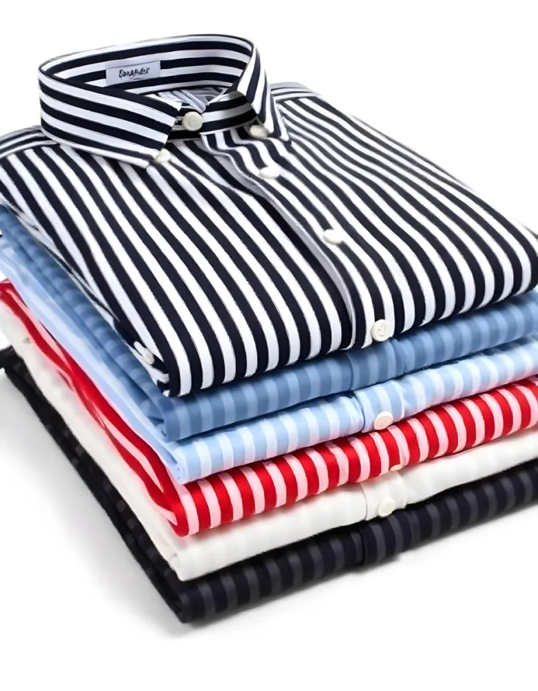 Stack Of Folded Shirts With Vertical Stripes In Black Blue Red And White Colors On A Black Surface 40 A950