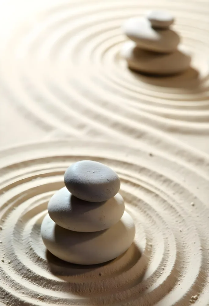 Three Stacked Stones On Sand With Concentric Circles The Background Is Made Of Sand With Parallel Circles 33 1541