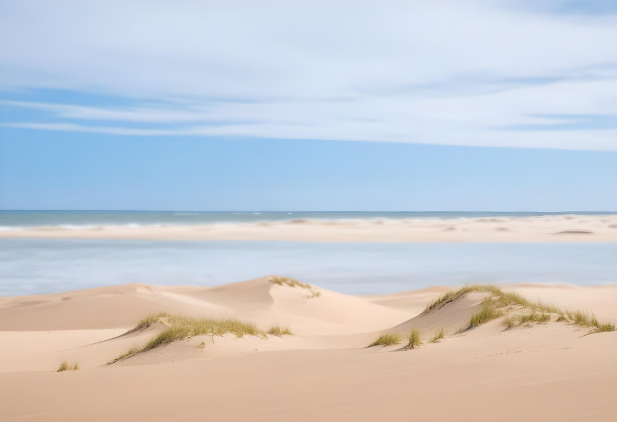 Sand Dunes On A Beach With A Blurred Blue Sky And Ocean In The Background 26 C0d8