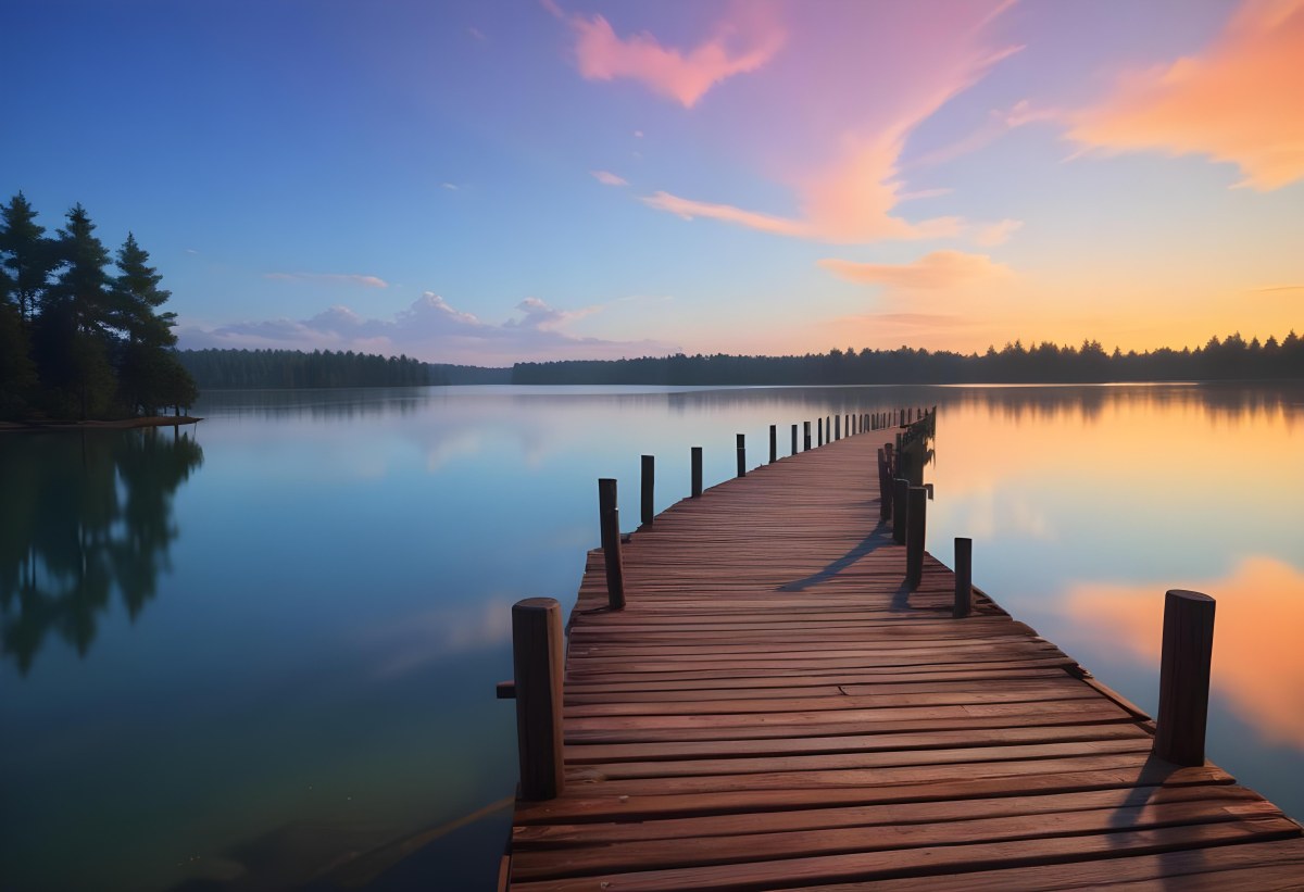 A Wooden Pier Stretches Out Into A Calm Lake The Sky Is A Mix Of Blue Orange And Pink Reflecting On The Water Trees Line The Shore In The Background 9 B631