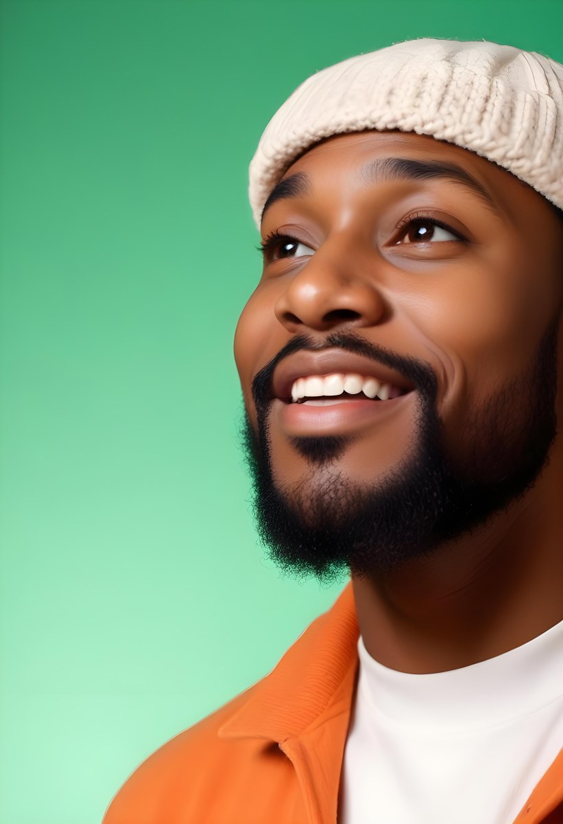 A Black Man 35 Years Old With A Beard And A Green Hat Looking To The Right On A Black Background 20 Ed40