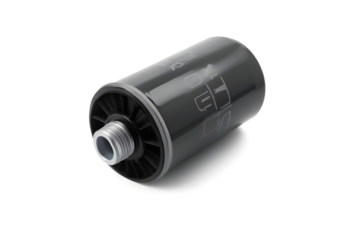 A Black Oil Filter With A Black Threaded Insert Lying On A Black Surface With A Slight Shadow Showcasing Its Cylindrical Shape And Construction 15 Cbc3